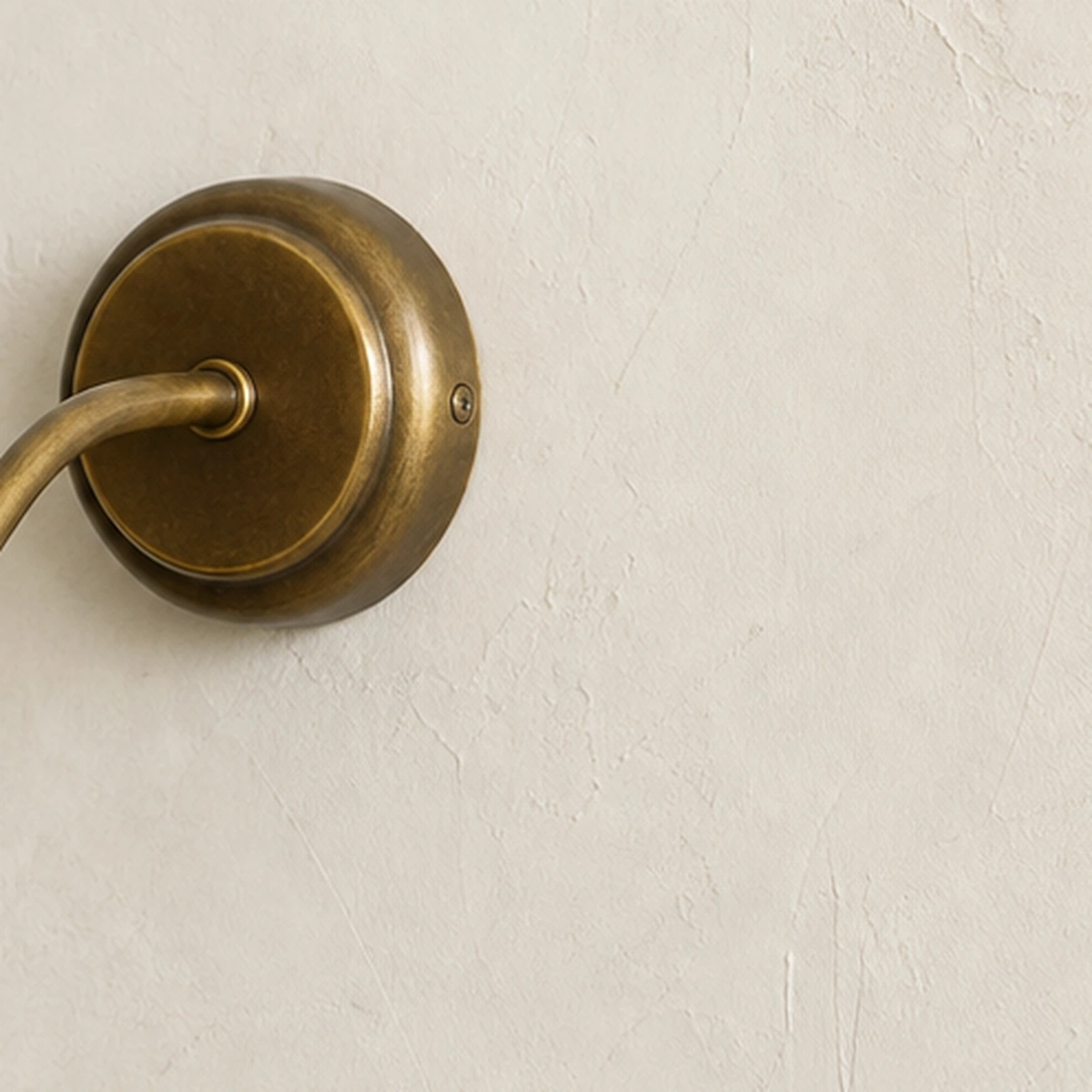 Round brass wall plate detail
