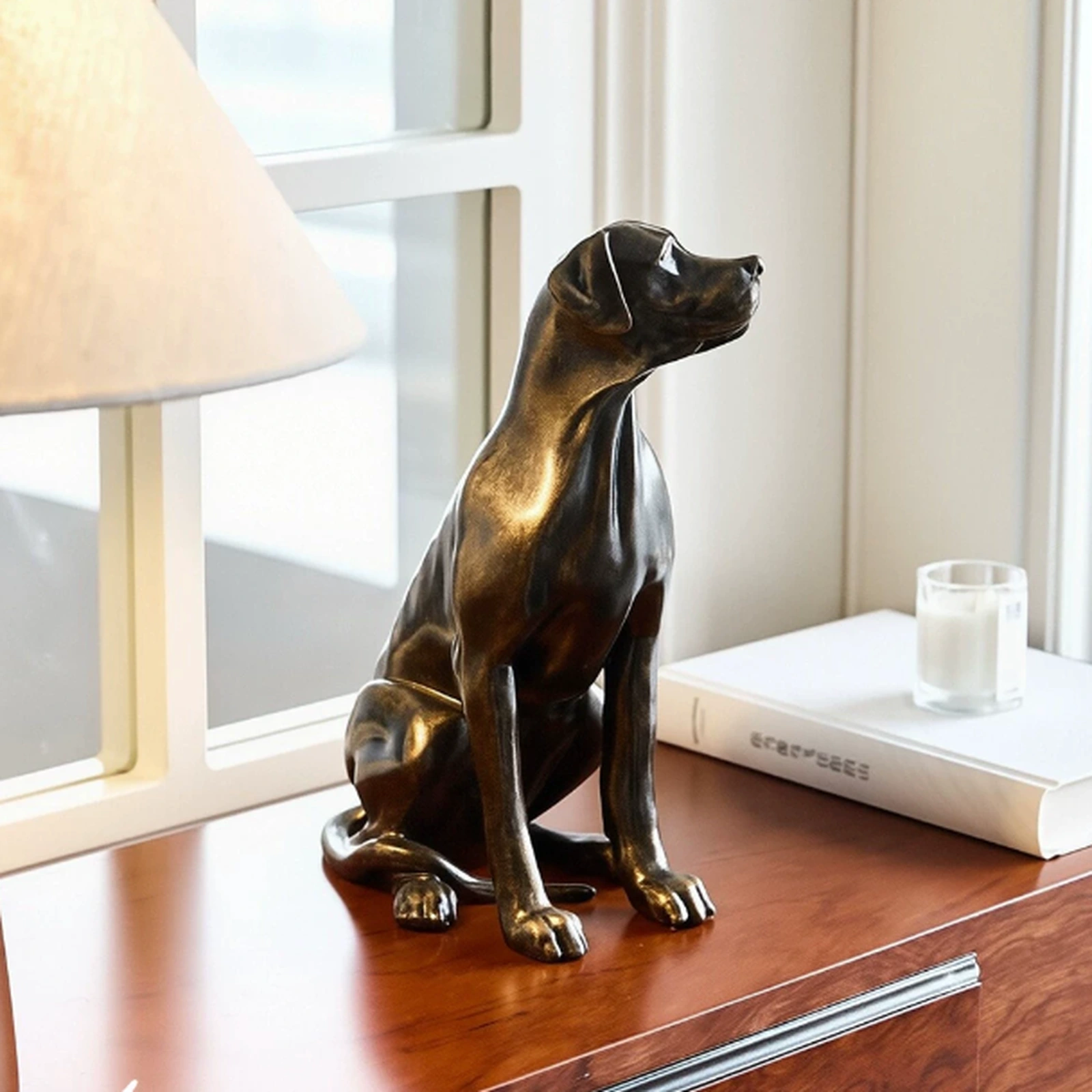 Dog sculpture styled near a window