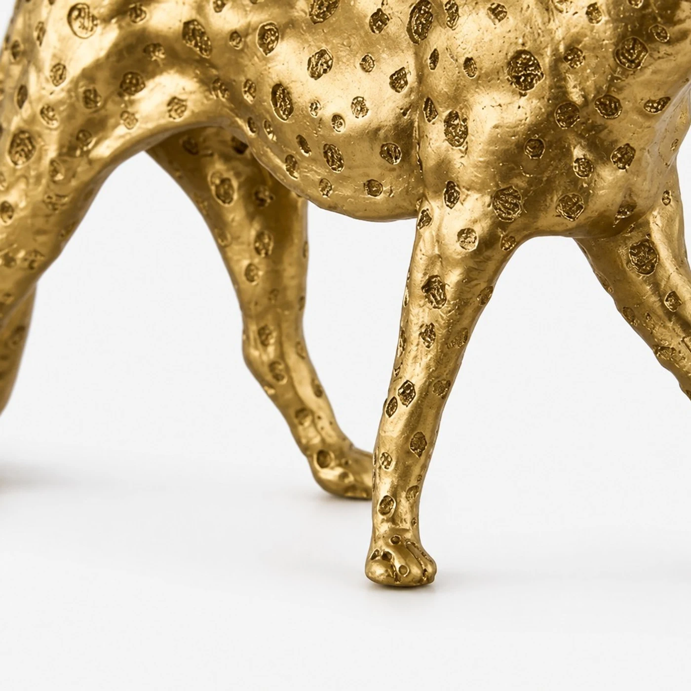 Close detail of leopard sculpture legs and walking stance