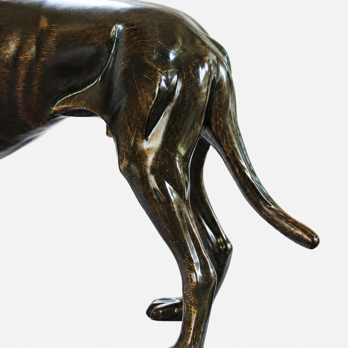 Tail and stance detail of the bronze dog sculpture