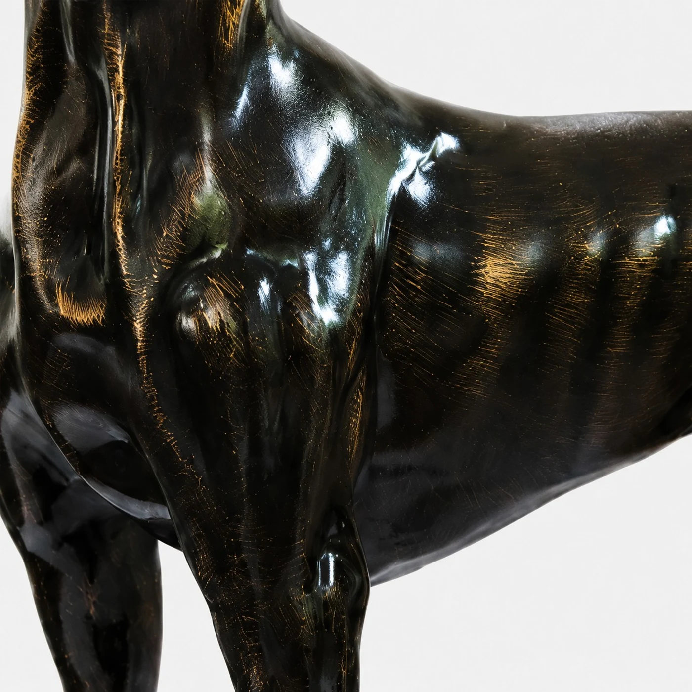Glossy bronze body texture detail on the resin dog sculpture