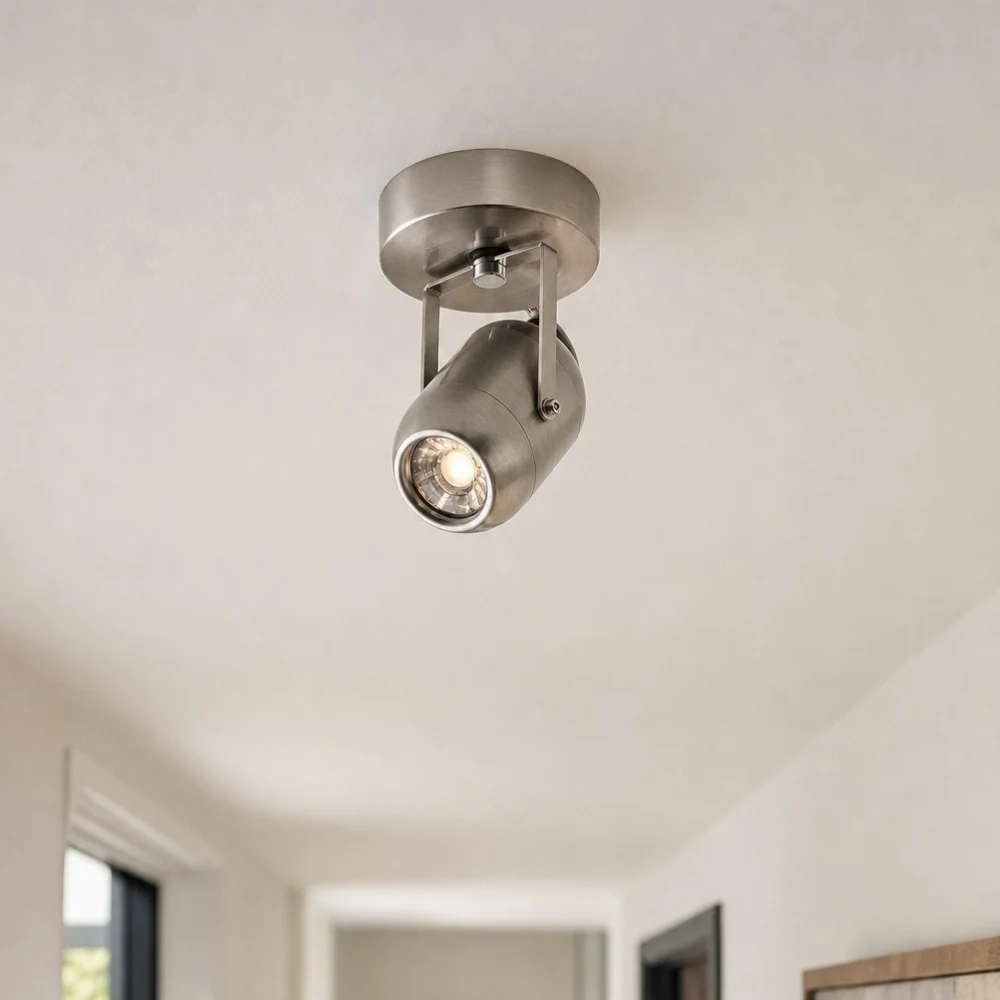 Compact metal wall lamp on a corridor ceiling