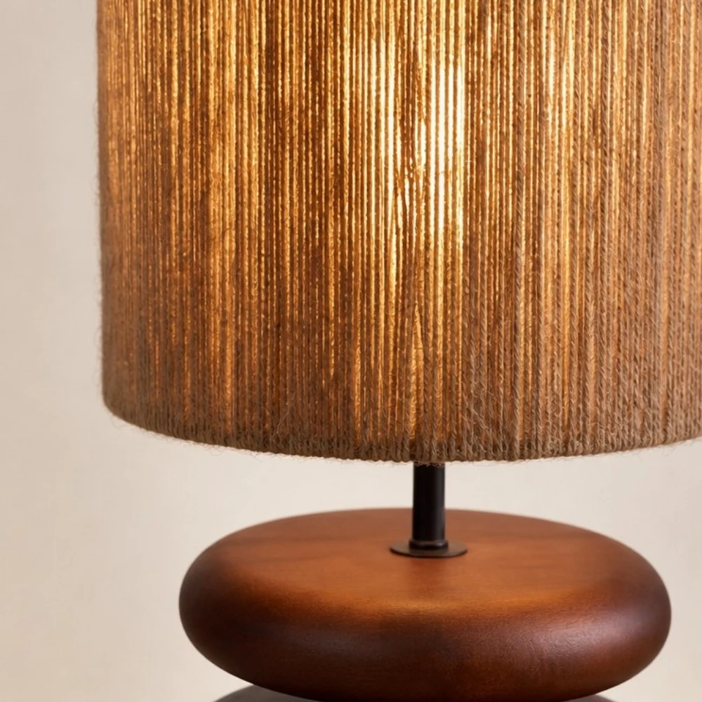 Warm glowing hemp rope shade on walnut wood table lamp