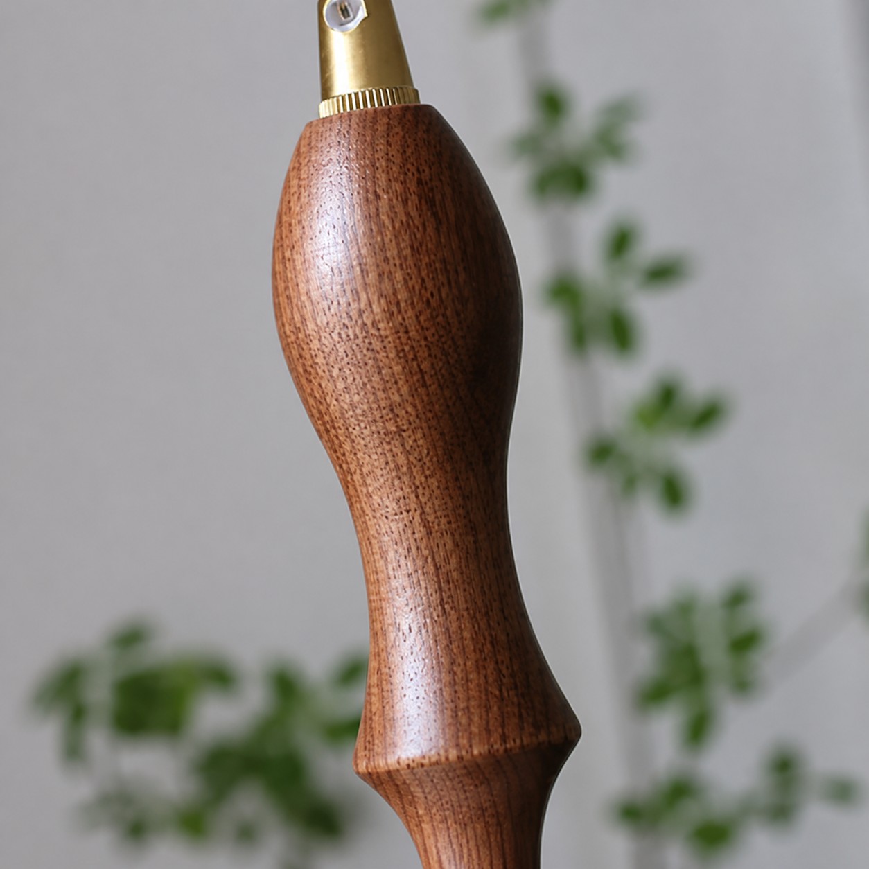 Close-up of walnut wood accent on pendant cord