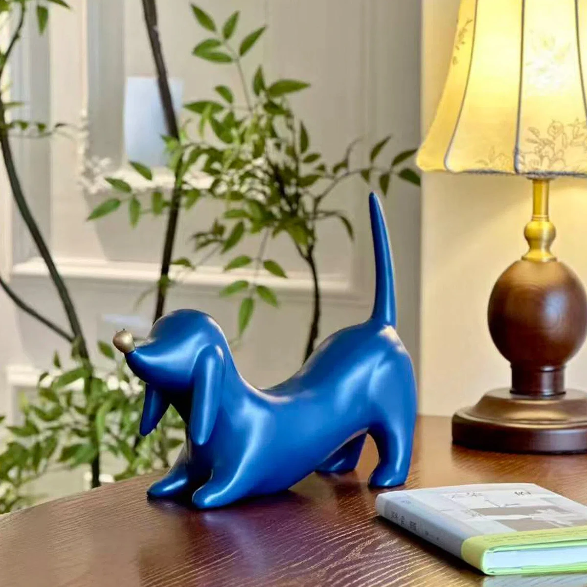 Blue dog sculpture beside a table lamp