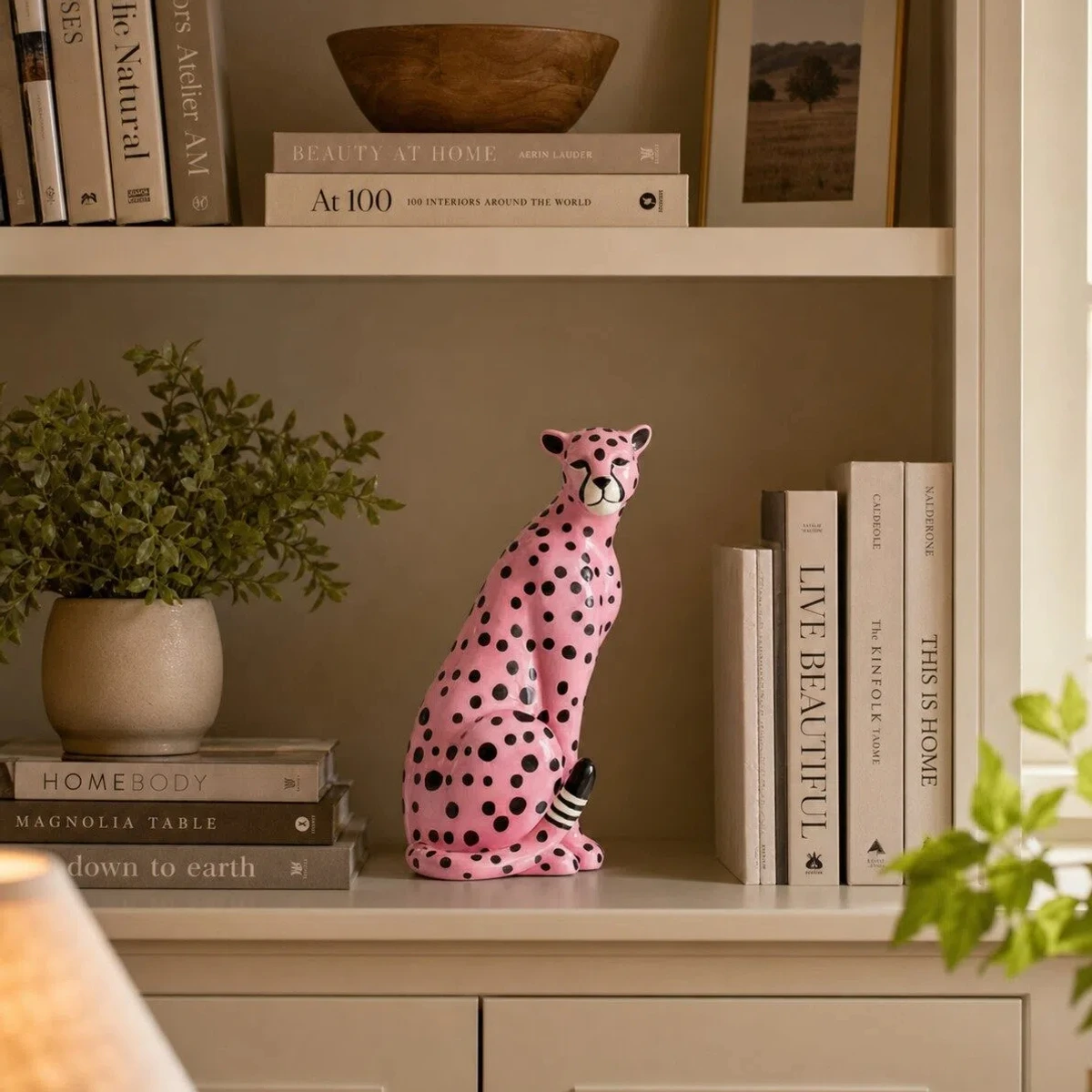 Pink leopard styled with books and greenery