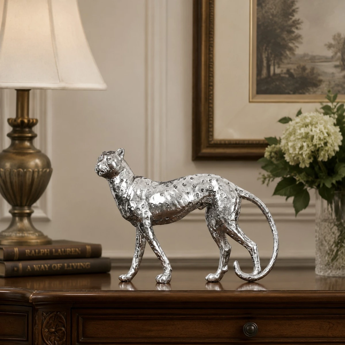 Silver standing leopard sculpture on a console table
