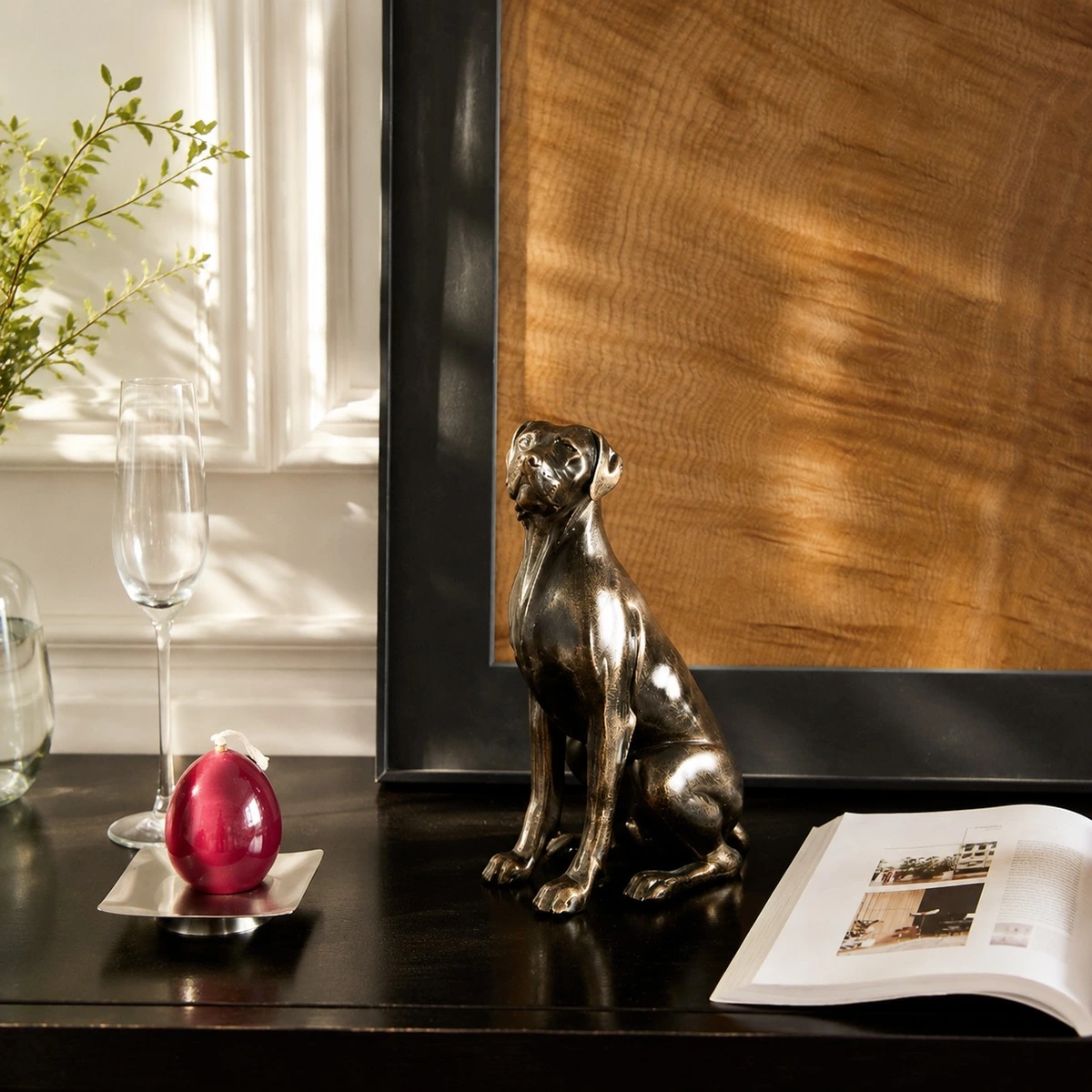 Black dog sculpture styled on a console