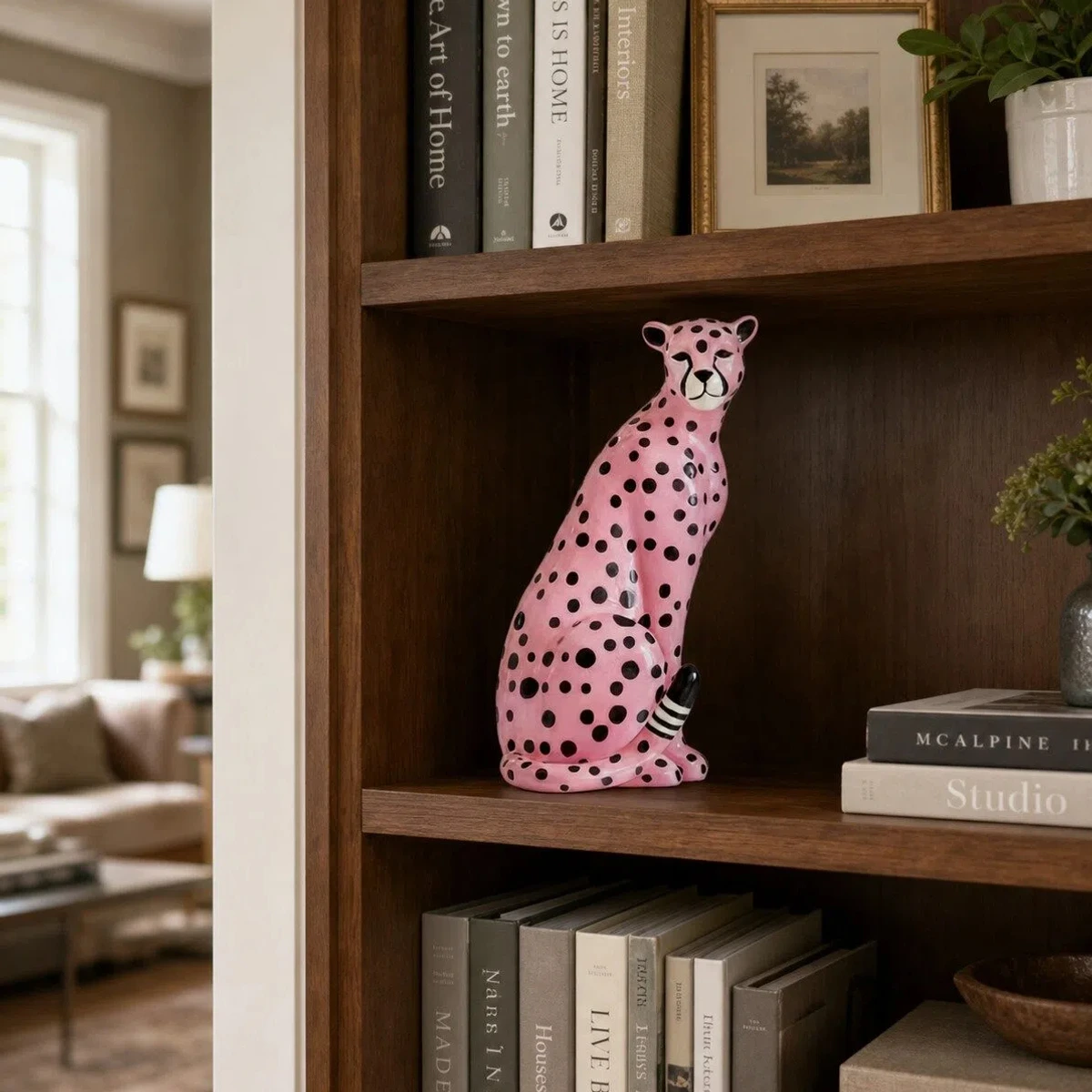 Pink leopard sculpture on a bookshelf near a living room