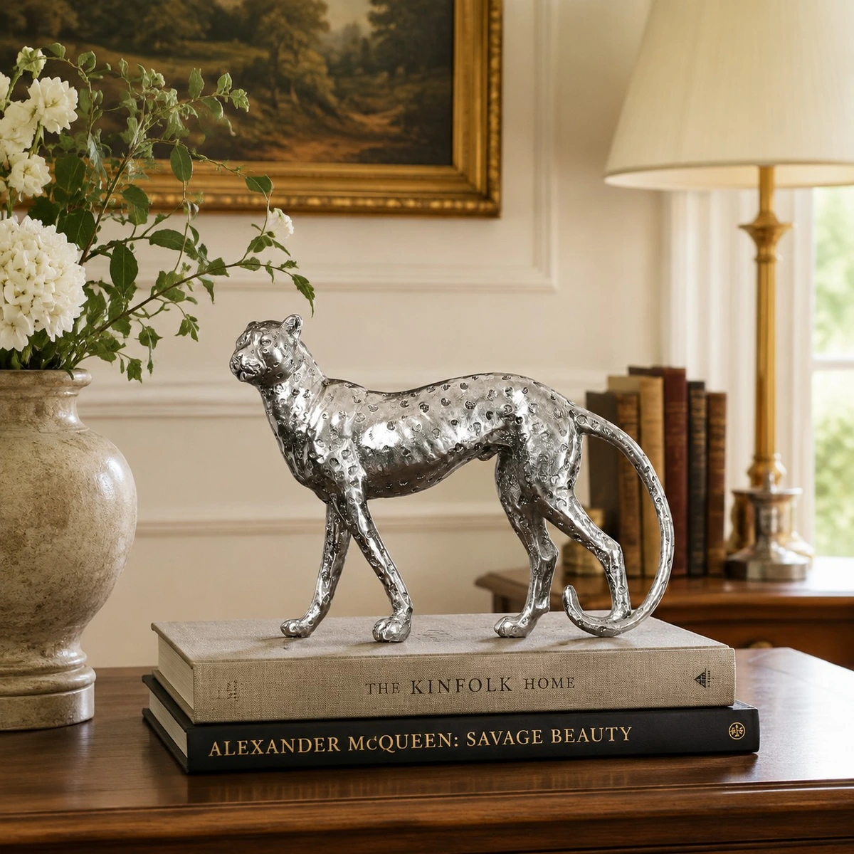Silver standing leopard sculpture styled on stacked books