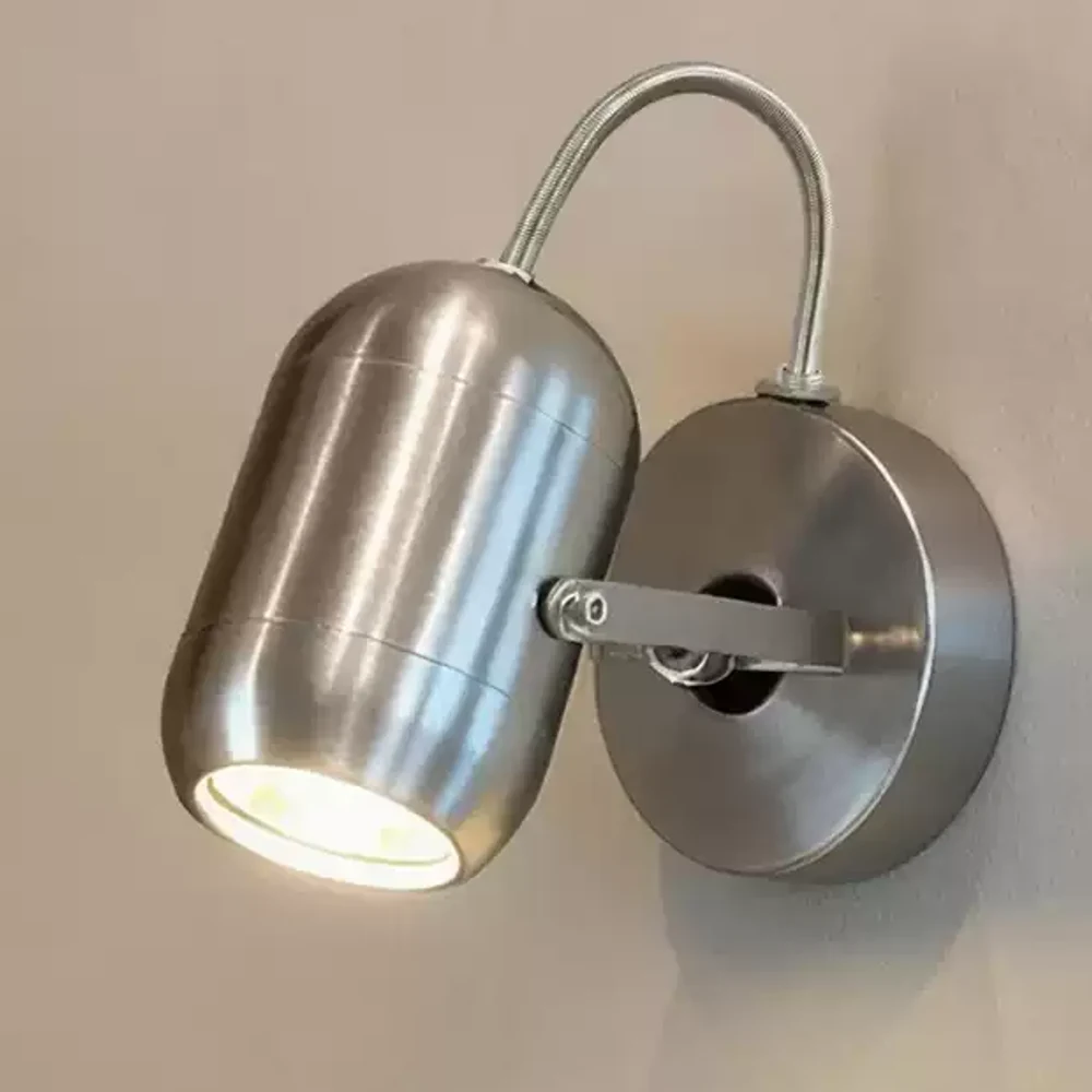 Close-up of brushed metal wall spotlight head and canopy