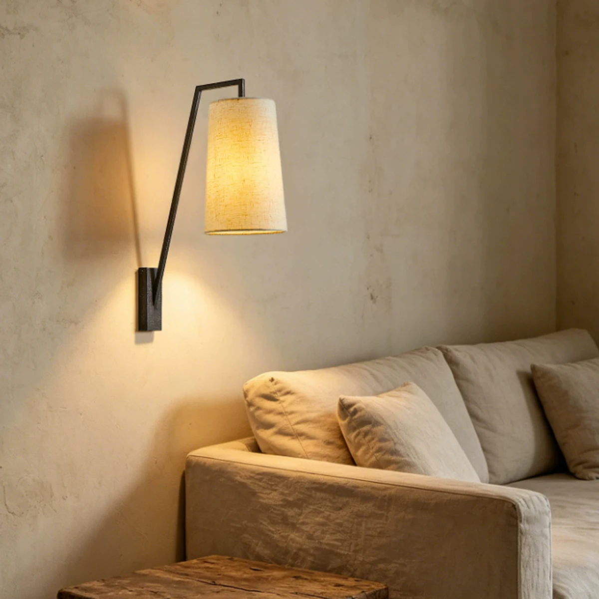 Vintage fabric shade wall lamp above a sofa
