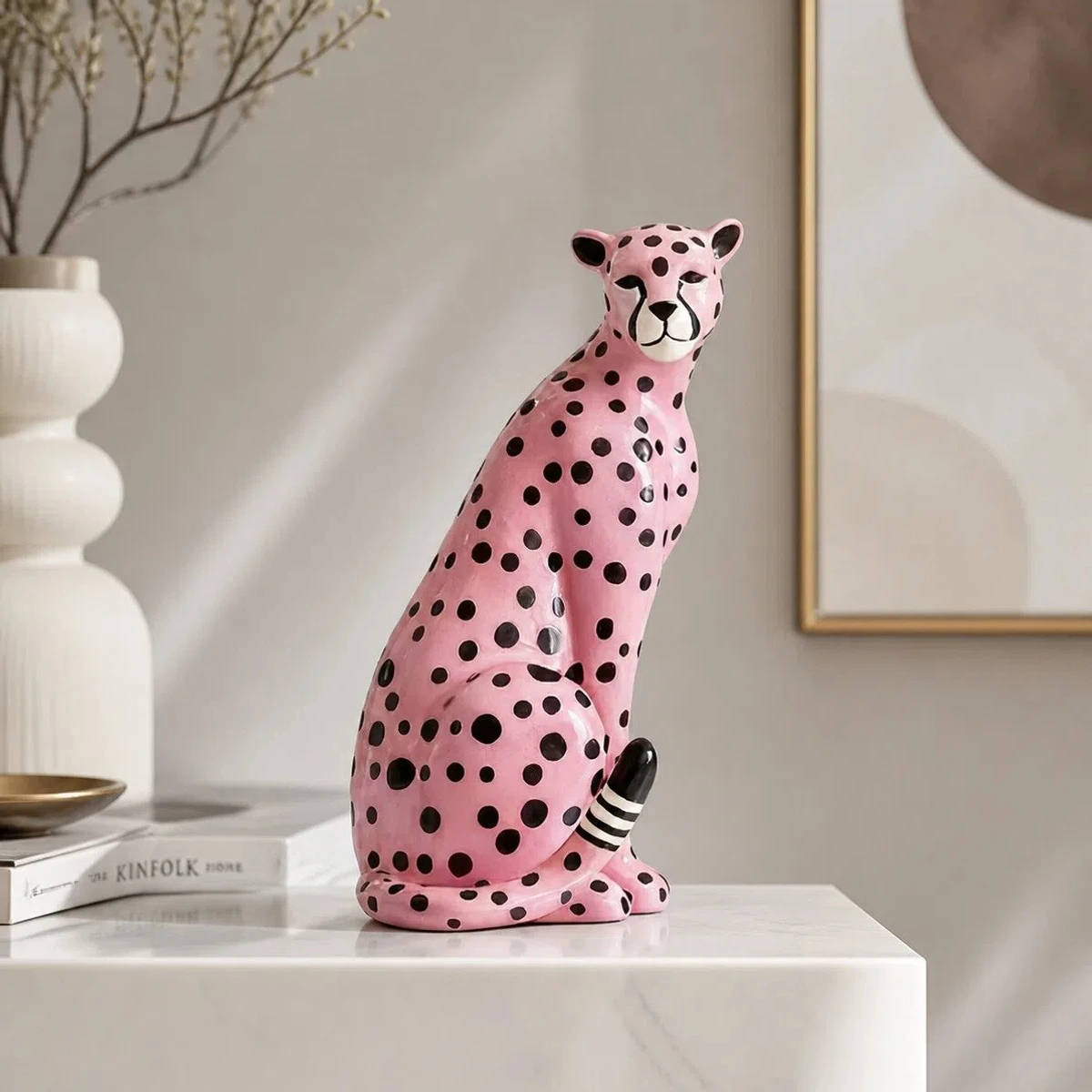 Pink leopard sculpture styled on a console table