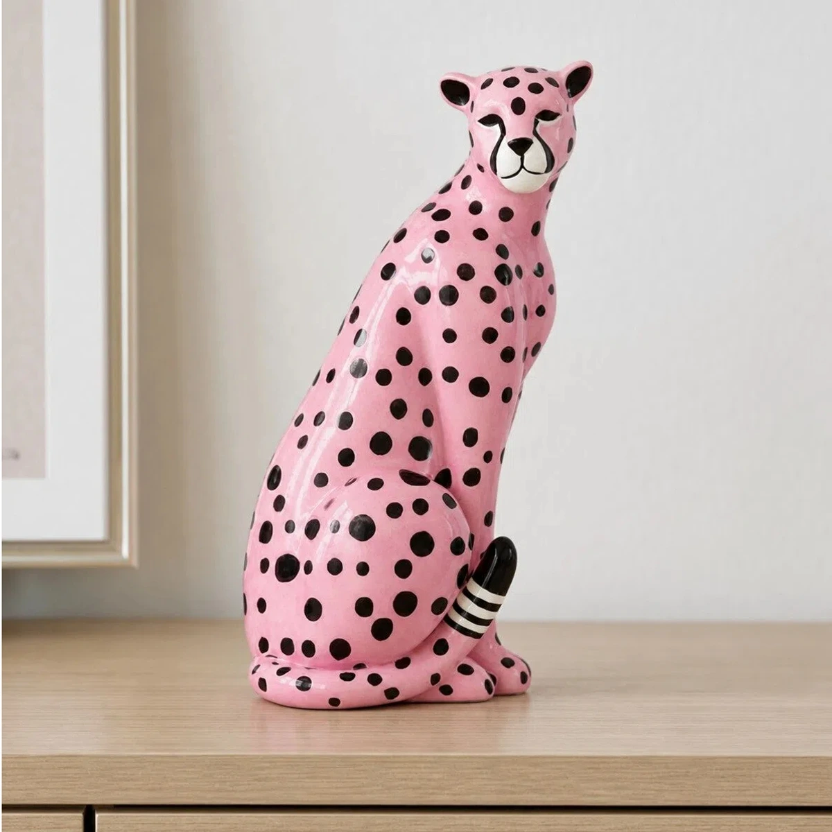 Pink leopard sculpture on a minimal desk