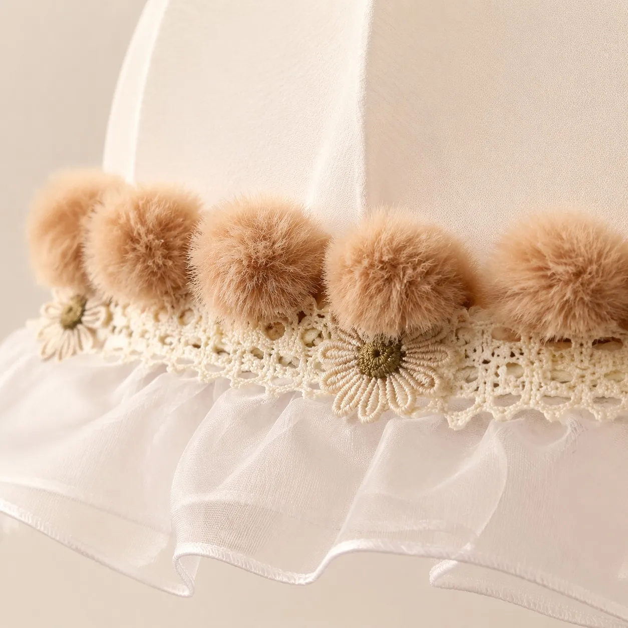 Warm camel pom-pom trim and floral lace detail
