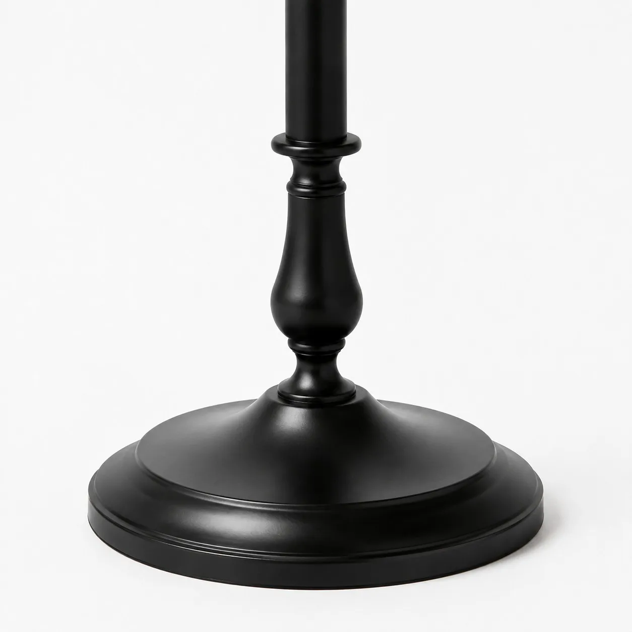 Close-up of stable round black iron floor lamp base